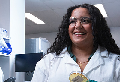 Photo of female manufacturing associate wearing goggles